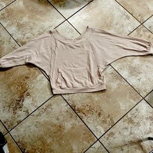 Beige ribbed sweater with a pocket in the front